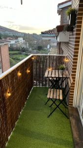a patio with a table and a bench on a balcony at Villa de Béjar 2 in Béjar