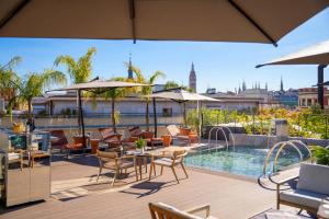 a patio with tables and chairs and a swimming pool at Ocean Drive Madrid in Madrid