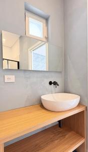 a bathroom with a sink and a mirror at Marina Palace Apartments & Terrace in Lipari +116 photos
