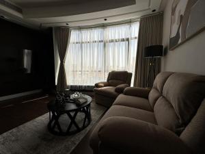 a living room with a couch and a table at Kindah Apartment in Jeddah