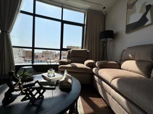 a living room with a couch and a table at Kindah Apartment in Jeddah