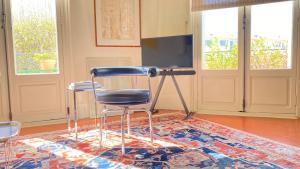 a chair sitting in front of a television in a room at Le Saint Apolline - Sète, Appartement Haussmanien in Sète