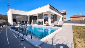 a villa with a swimming pool and a house at Poolside Idyll in Bar