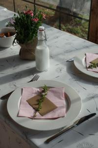 a table with a plate with a bottle of milk at OberWood in Porumbacu de Sus