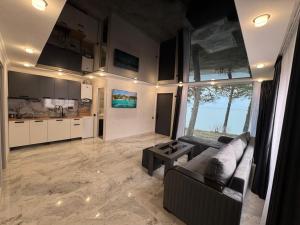 a living room with a couch and a kitchen at Nirvana Lake View in Sevan