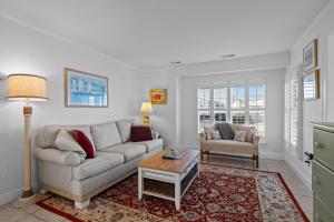 a living room with a couch and a table at Salt Life home in Atlantic Beach +36 photos