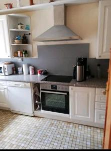 a kitchen with white cabinets and a stove top oven at Eselhof Oberlascheid in Oberlascheid