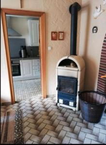 a fireplace in a room with a stove in a kitchen at Eselhof Oberlascheid in Oberlascheid
