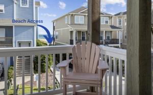 a rocking chair on the balcony of a beach house at Slack Tide condo in Atlantic Beach