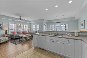 a kitchen with a sink and a living room at Slack Tide condo in Atlantic Beach +44 photos