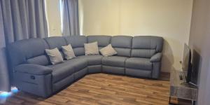 a blue couch in a living room with a television at The Palms in Loxton