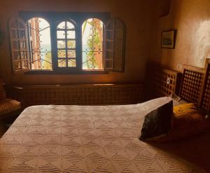 a bedroom with a bed and a window at Villa Oceane in Taghazout