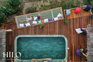 an overhead view of a swimming pool on a wooden fence at Turtle Beach Villa les 3 Bassins by HILO Collection - 14 people - Pool, gym and Ocean private access in La Saline Les hauts 
