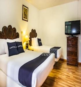 Postel nebo postele na pokoji v ubytování Capital O Hotel Central, Xalapa