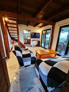 a bedroom with two beds and a staircase in a room at English Cottage House Tagaytay in Calaca
