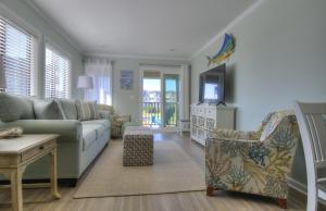 a living room with a couch and a tv at Southwinds J6 condo in Atlantic Beach