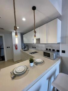 a kitchen with a counter with two plates on it at شقة فاخرة بإطلالة بحرية في داماك in Jeddah +16 photos