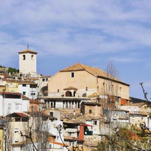 a building on top of a hill with a tower at Apartamento La Plaza! in Bogarra