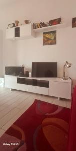 a living room with a flat screen tv on a wall at appartamento sapore di mare in Pozzallo