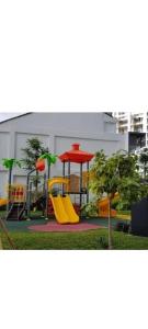 a playground with a yellow slide and a red structure at Apartemen puri mansion in Jakarta