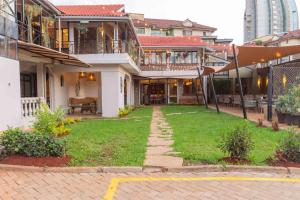 a house with a lawn in front of it at Trisan Resident Hotel in Nairobi