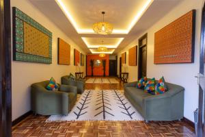 a living room with couches and a hallway at Trisan Resident Hotel in Nairobi