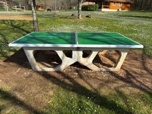 a ping pong table in the middle of a field at LES REFUGES DU LOT Kouki's Lodge in Mauroux
