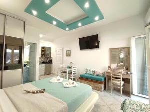 a bedroom with a bed and a kitchen with a table at Fantastic View Suite Kythnos in Kithnos