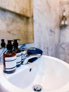 a bathroom sink with two bottles of soap on it at View Talay Villas 3 Bed Rooms Private Pool in Jomtien Beach +21 photos
