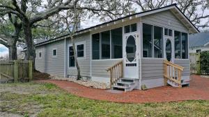 a tiny house with a porch and large windows at Mr, Bennie's Cafe home in Harkers Island +29 photos