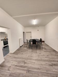 an empty room with a table and chairs in it at BS Monteurunterkunft BE1 in Bergisch Gladbach