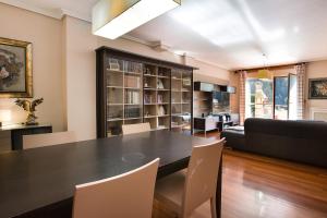 a living room with a black table and chairs at Spacious Villa with Pool Plentzia Bilbao Area in Mendiondo