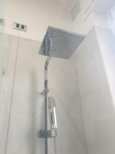 a shower head in a bathroom with a shower at La Perla dell' Adriatico Apartments - Perla Aurea - in Termoli +11 photos
