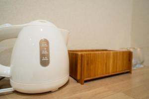 a white mixer sitting on top of a wooden table at 久宿 東山 Hisaya Higashiyama Room C in Kyoto