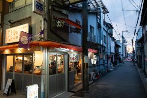 a street with a restaurant on the side of a building at 久宿 東山 Hisaya Higashiyama Room C in Kyoto