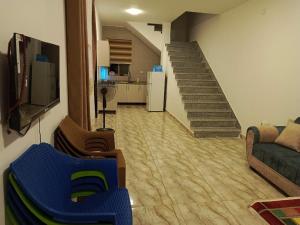 a living room with a staircase and a couch at شاليه الاميرات in Sowayma