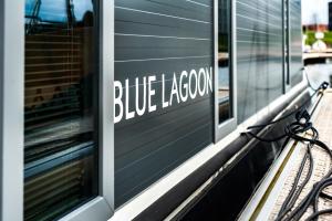 a blue lagoon sign on the side of a building at Waterlodge voor 4 personen in de haven van Kamperland in Kamperland