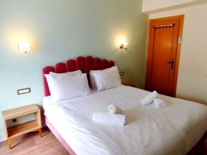 Postel nebo postele na pokoji v ubytování La Perle City Center Rooms