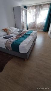 a large bed sitting in a room with at Apartament II Na Słonku in Dzierzgoń