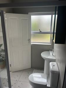 a bathroom with a toilet and a sink and a window at 16Park in Stikland +14 photos
