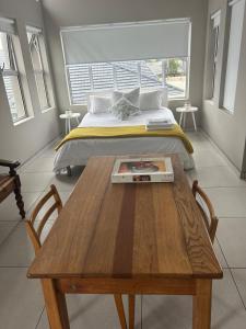 a bedroom with a bed and a wooden table at 16Park in Stikland