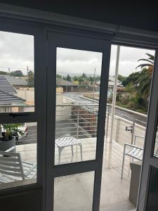 a glass door with a chair on a balcony at 16Park in Stikland