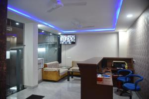 a living room with a blue led ceiling at Hotel Siddharth Inn, Raipur Junction in Raipur