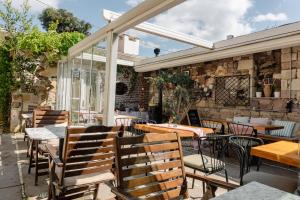 an outdoor patio with chairs and tables and a window at Cunda ILIOS in Ayvalık +177 photos