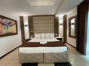 A bed or beds in a room at Presken Hotel at International Airport Road