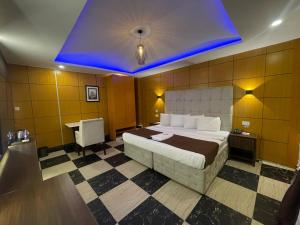 A bed or beds in a room at Presken Hotel at International Airport Road