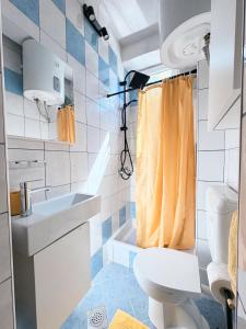 a small bathroom with a toilet and a sink at Rooms Kate in Krk +16 photos
