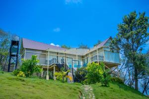 a large house on top of a hill at Yanai at Anai - Private Pool & Private Cook in Varagampadi