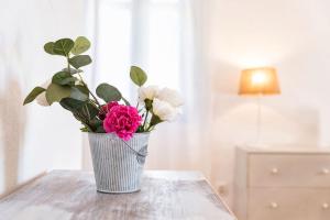 a vase filled with flowers sitting on a table at Sun Drop 1 with private pool, 5-min walk to Drios beach in Drios
