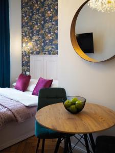 a room with a table and a bed and a mirror at Stupartska Grand Residence in Prague